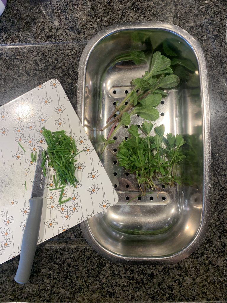 Fresh herbs on a kitchen counter.